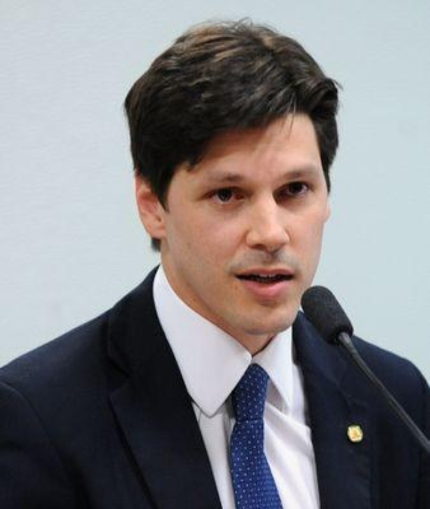 A suited man speaks into a microphone, likely addressing the government's approval of a bill to ban internet use.