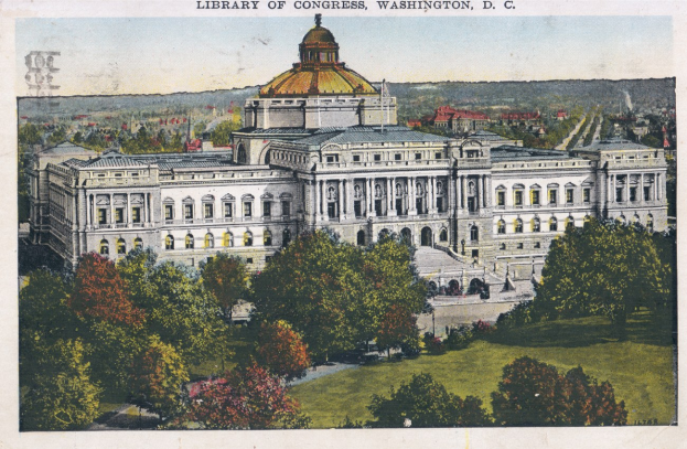 Old postcard of the Library of Congress in Washington, DC, depicting a large domed building with trees and grass in the foreground under a clear blue sky, with text at the top.