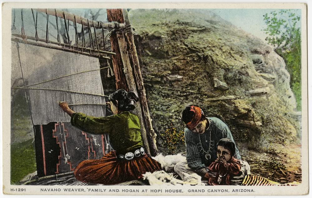 Old postcard showing a Navajo woman and two children weaving on a wooden loom at Hopi House in Grand Canyon, Arizona, with hills and trees in the background and text at the bottom.