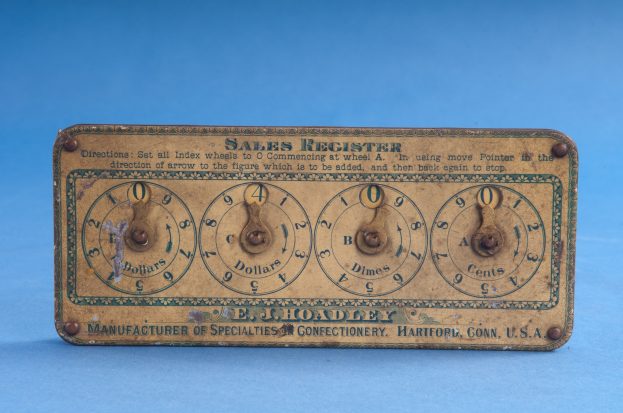 Altmodisches Verkaufsregister mit Text und Zahlen auf einem blauen Hintergrund, das wahrscheinlich das Datum und die Uhrzeit anzeigt.