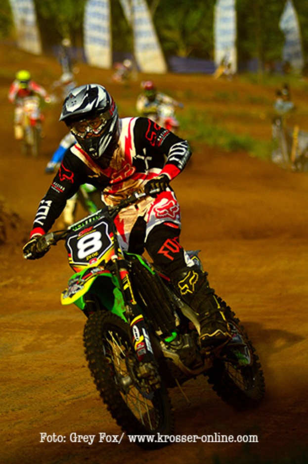 A group of motorcyclists racing with helmets, featuring text at the bottom.